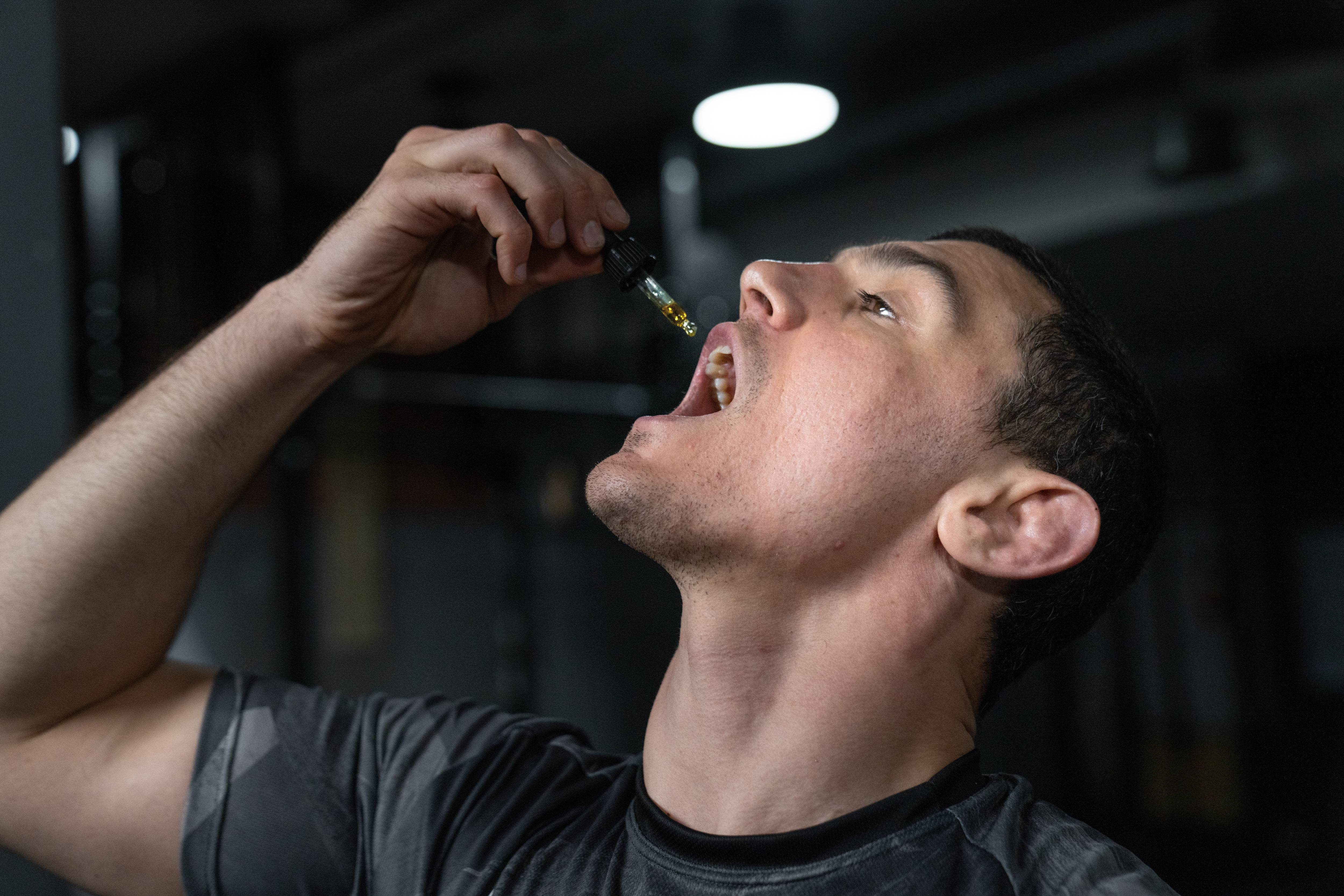 Man using an enjoyable CBD tincture after a workout. 